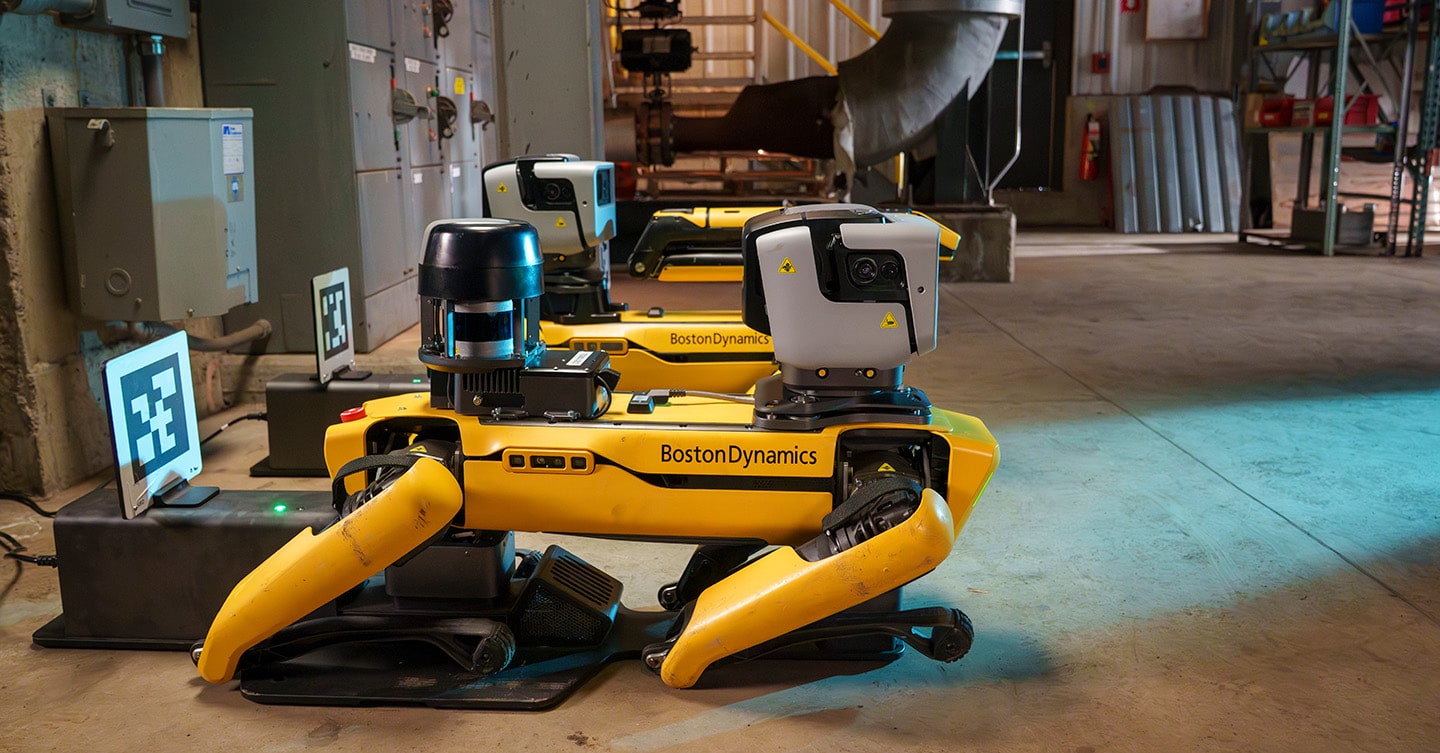 Two Spot robots recharging on their docks, in between inspection missions