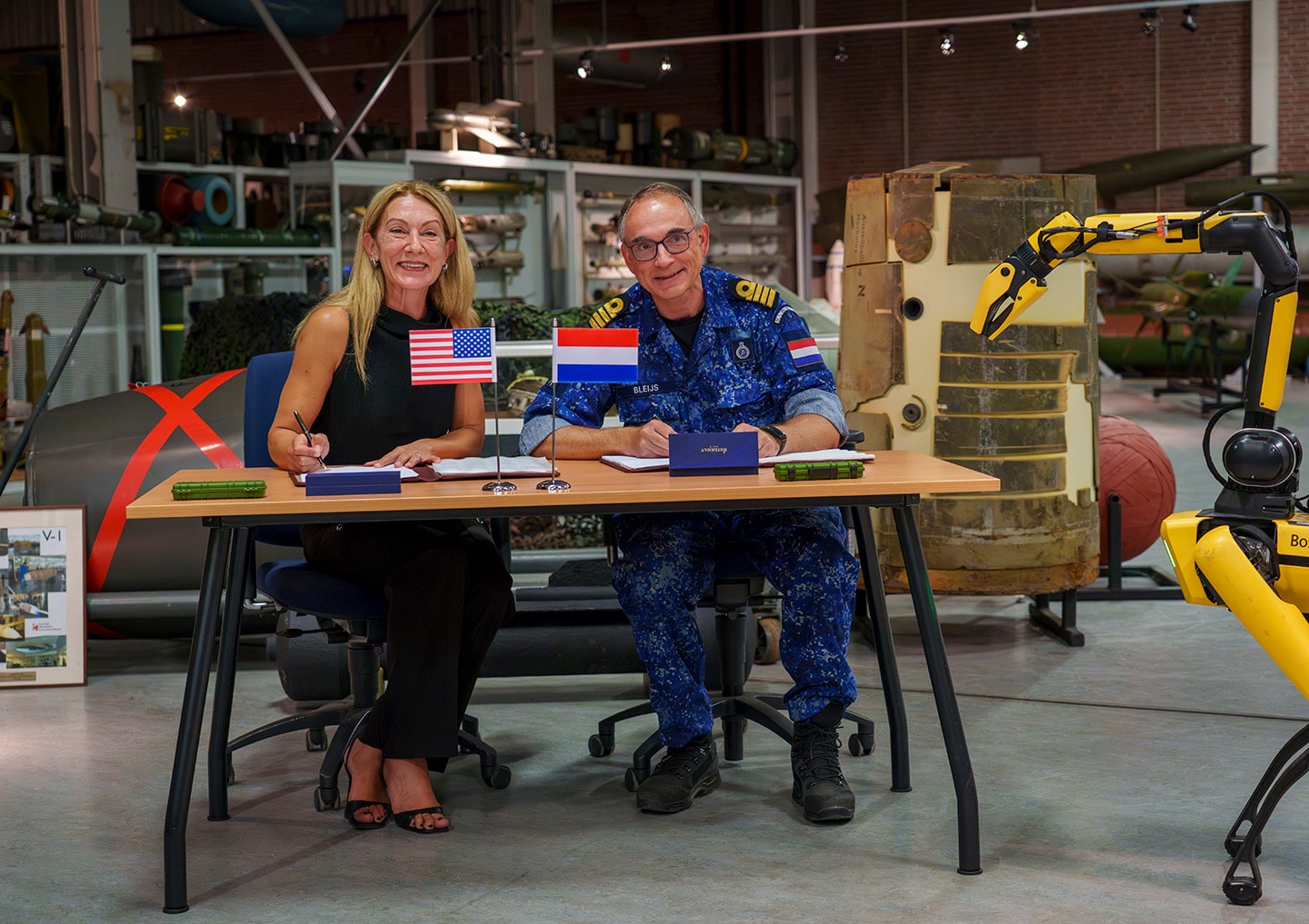 Representatives from Boston Dynamics and the Netherlands Ministry of Defence sign agreement