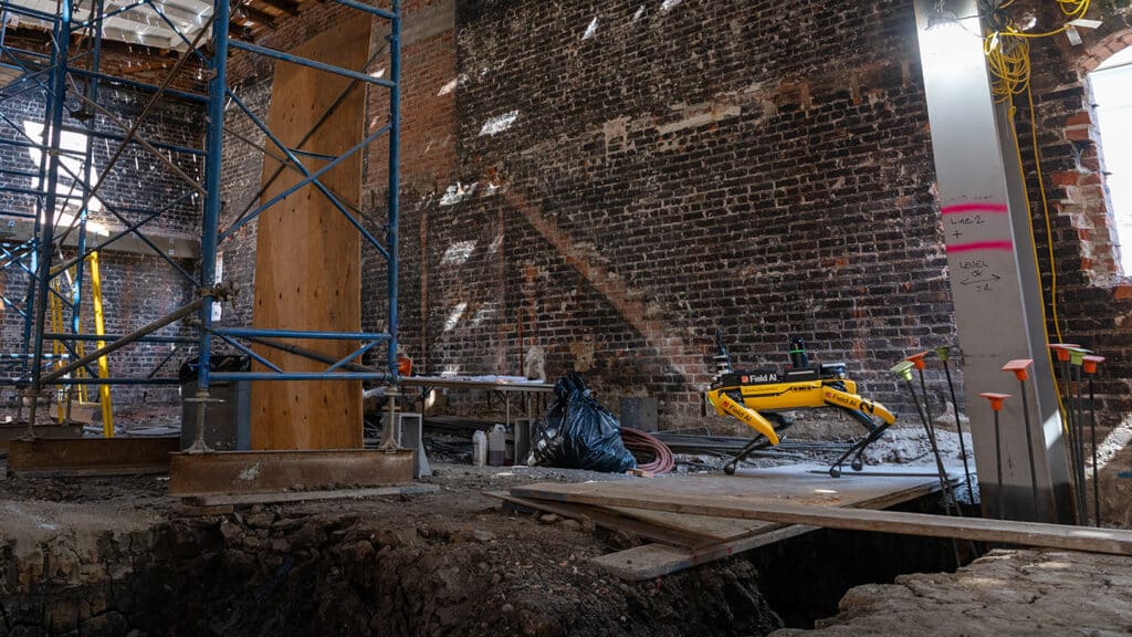 Spot walks through a messy, complex construction environment