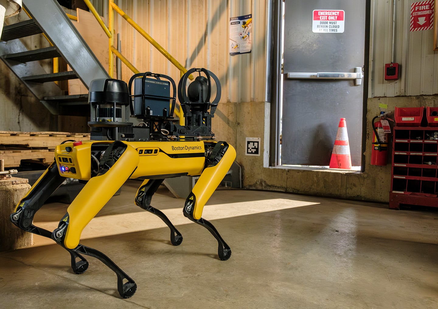 Spot inspects a propped door in a manufacturing facility
