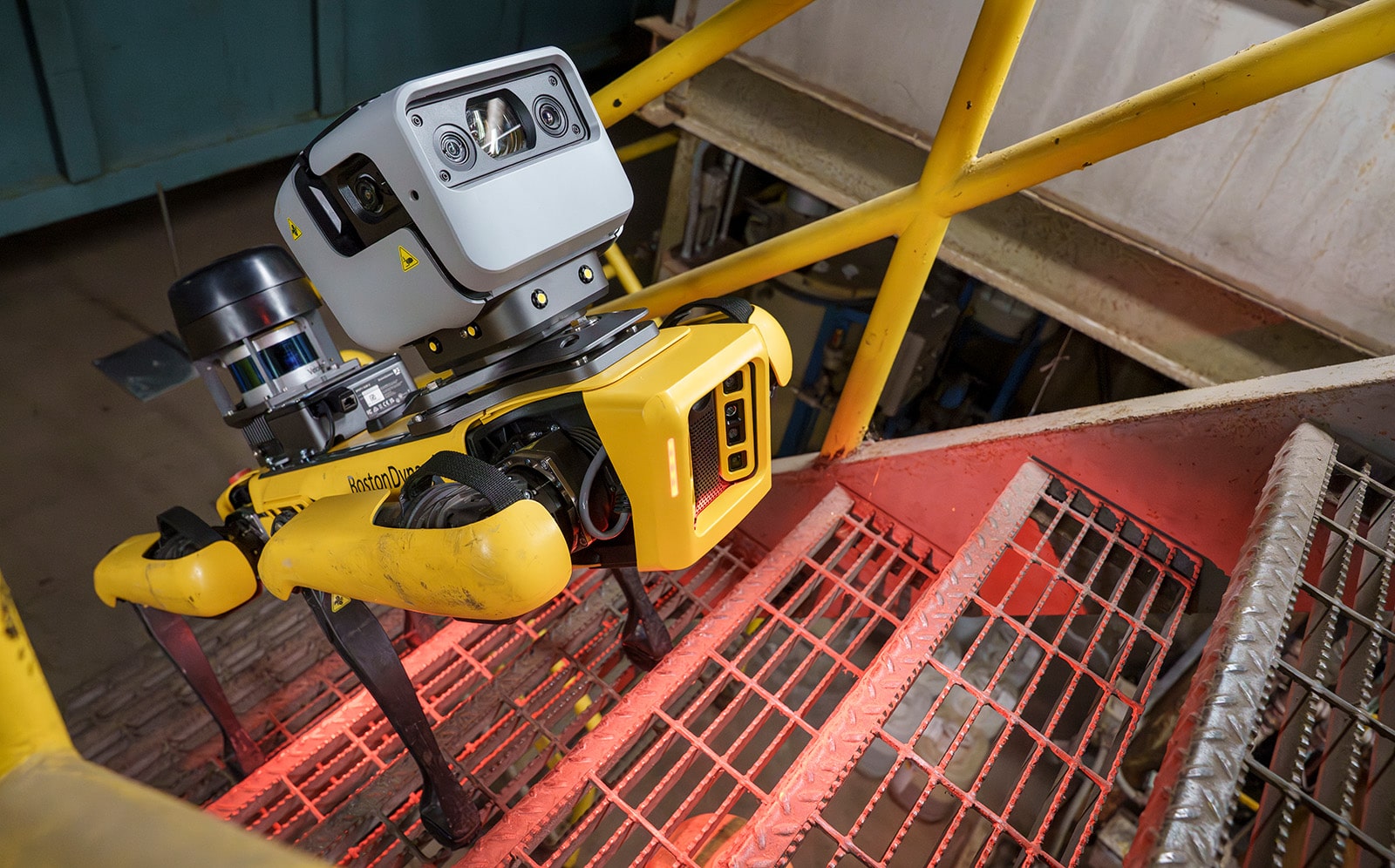 Spot with industrial sensing payloads walks up grated stairs