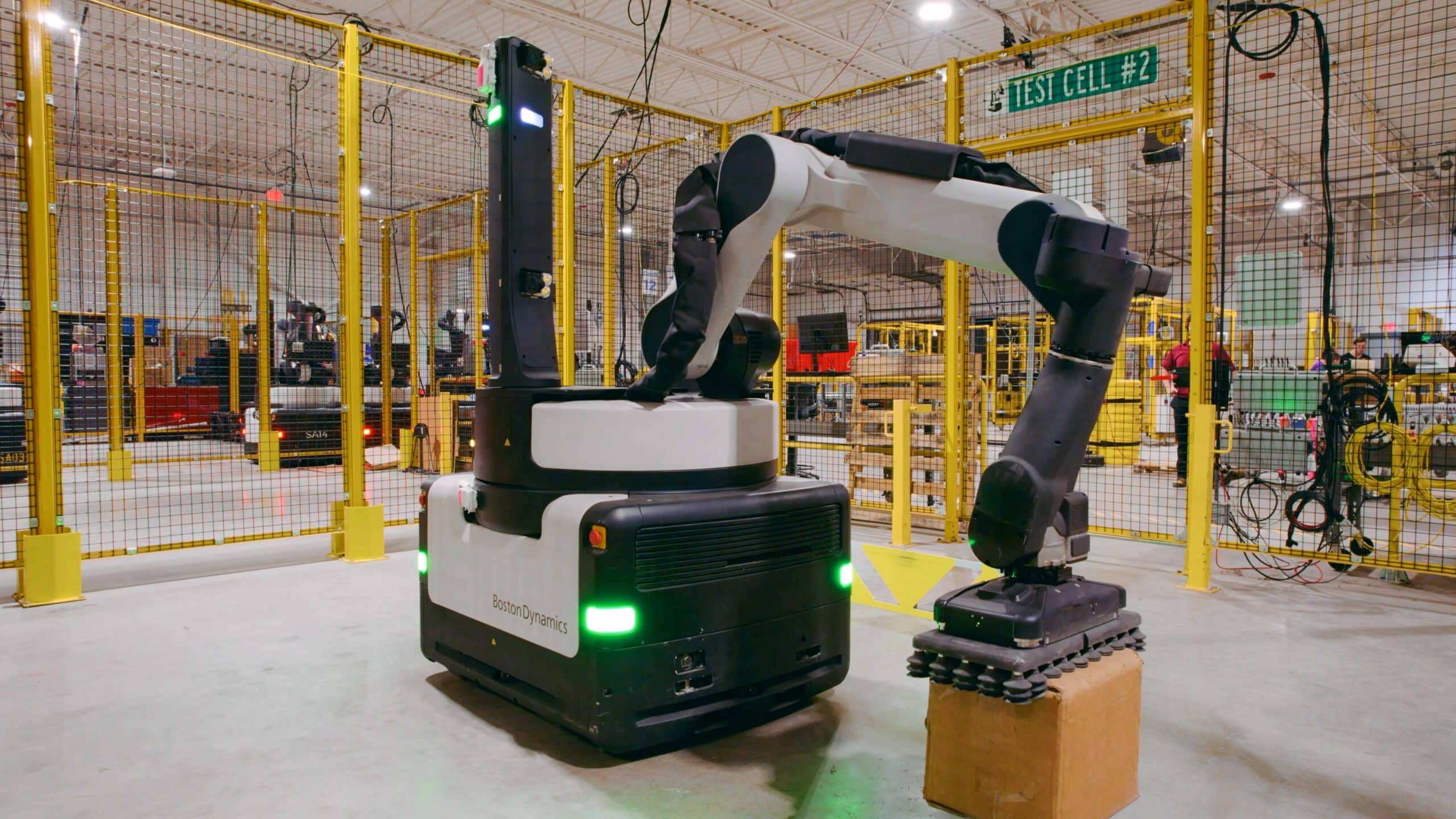 A robot with an industrial arm places a box down